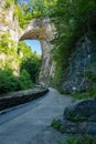 Visitors under the Rock Arch at Natural Bridge State Park, Virginia, USA Royalty Free Stock Photo